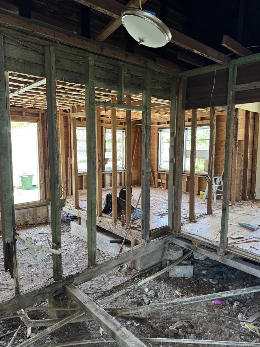 Exposed wall and floor framing during a renovation project.