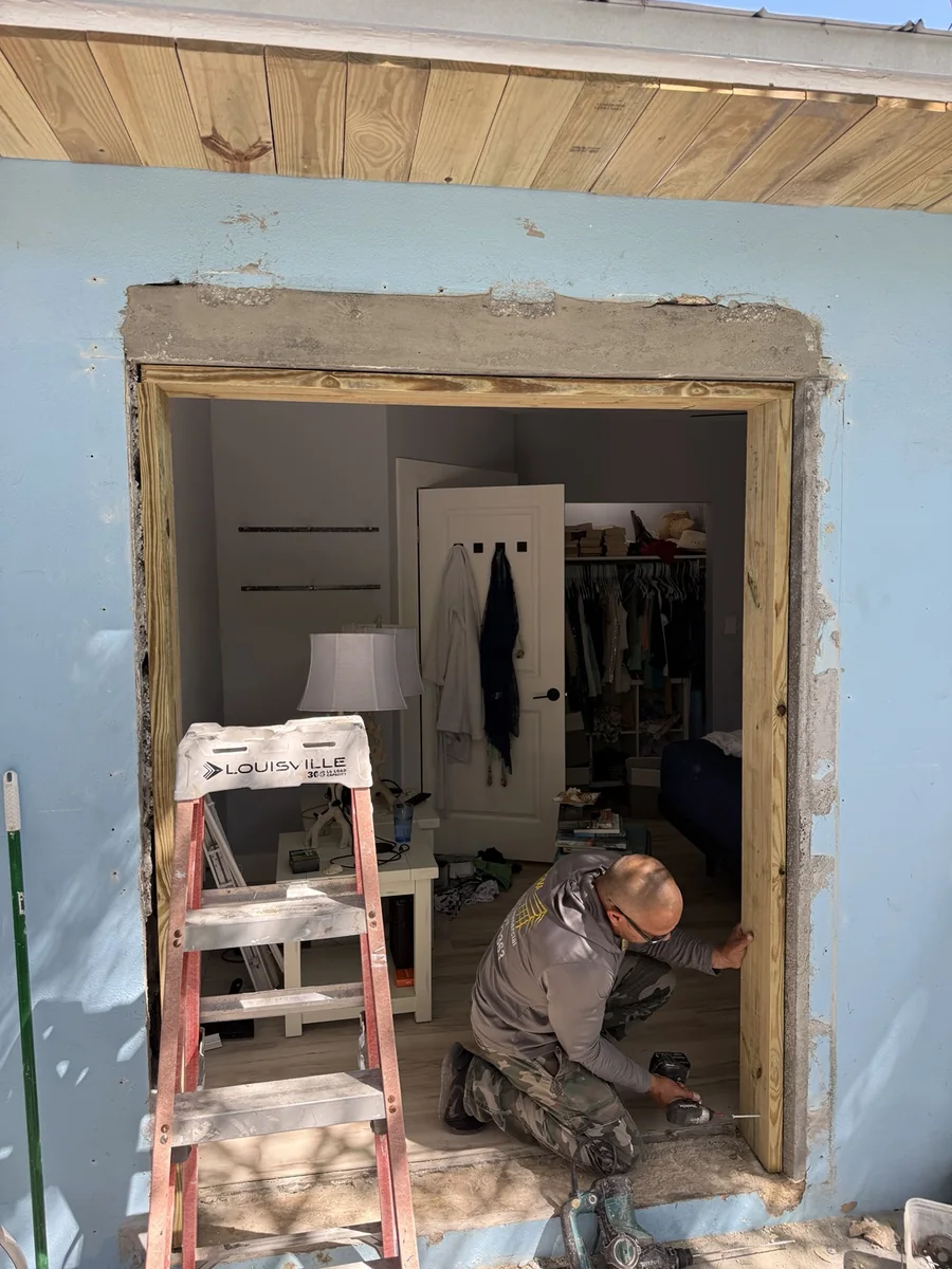 Carpenter working on a newly framed opening in an existing structure.